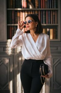 Confident woman standing in city street, symbolizing aging gracefully